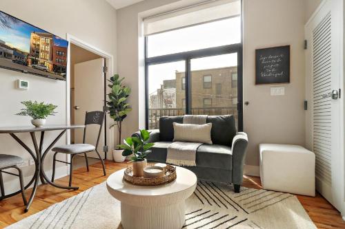 a living room with a couch and a table at Splendid & Fully Furnished 1BR Apartment - Broadway 204 rep in Chicago