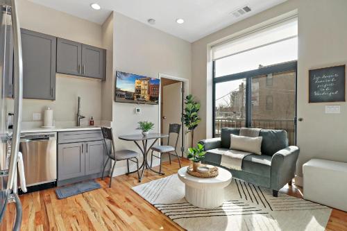 a kitchen and living room with a couch and a table at Splendid & Fully Furnished 1BR Apartment - Broadway 204 rep in Chicago