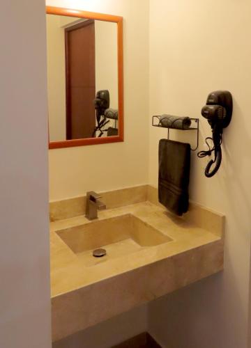 a bathroom with a sink and a mirror at Departamento a 200 Mts de la playa y alberca en planta baja in Mazatlán