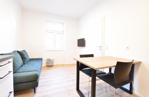 a living room with a table and a couch at myQuartier Central City Suites in Innsbruck