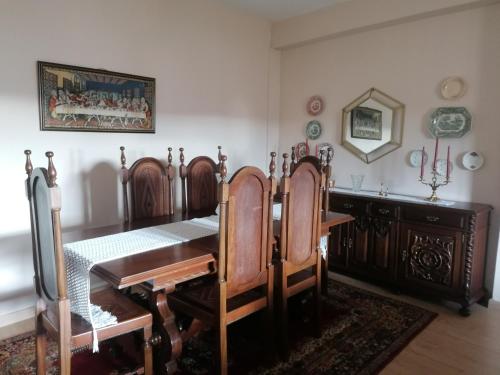 a dining room with a wooden table and chairs at Casa do Bonifácio in Vilarinho