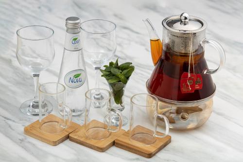 a table with wine glasses and a blender at Veliton Hotel in Al Khobar