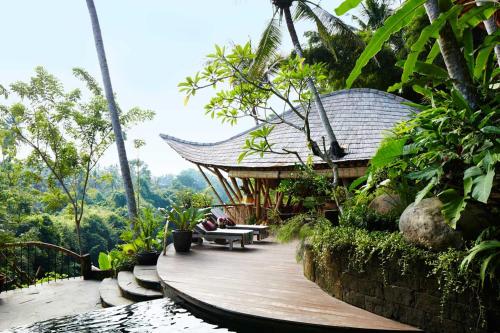 une passerelle en bois menant à un bâtiment dans une forêt dans l'établissement Ananda House 3bds Eco Bamboo House Pool River View, à Bringkit