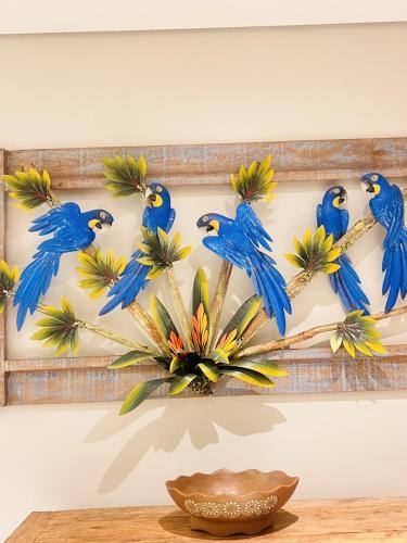 a group of blue birds hanging on a wall at Paraiso Beach Hotel in Aquiraz