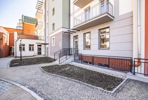 an empty street in front of some buildings at Apartament Ania Stare Miasto in Elblag