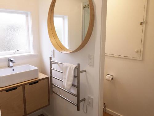 a bathroom with a sink and a mirror at 15 Bristol Street in Hanmer Springs