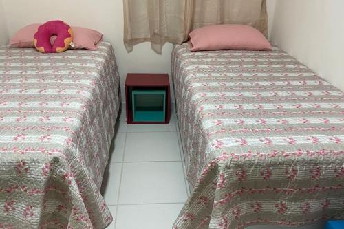 two beds sitting next to each other in a room at Brisas do Lago in Paulo Afonso