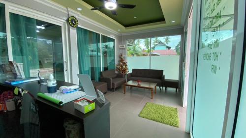 an office with a desk with a computer on it at Norshah Village Resort in Pantai Cenang