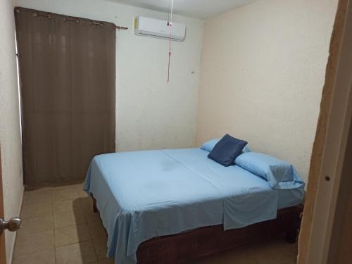 Un pat sau paturi într-o cameră la Casita Mahahual, Grand Costa Maya