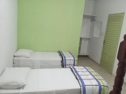 A bed or beds in a room at POUSADA SÃO MATHEUS