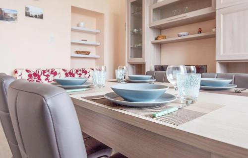 a dining room with a table with blue bowls and chairs at Oasi Dei Cervi in Guspini