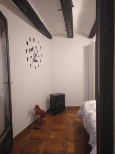a room with a clock on the wall and a dog on the floor at JUNTO AL PILAR in Zaragoza