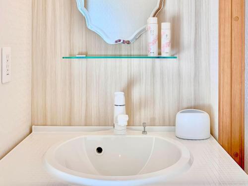 a bathroom with a white sink in a room at Sparky’s House in Naoshima