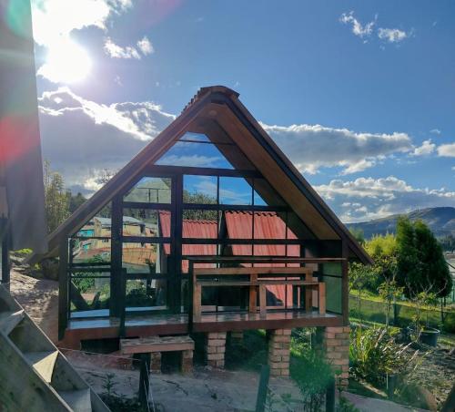 a small house with a large glass window at Hospedaje Villa Rosita Suesca in Suesca