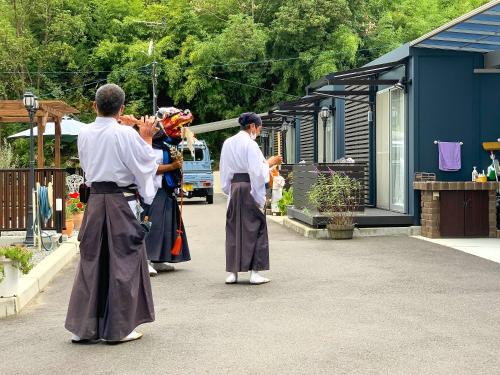 a group of people standing outside of a building at Sparky’s House in Naoshima