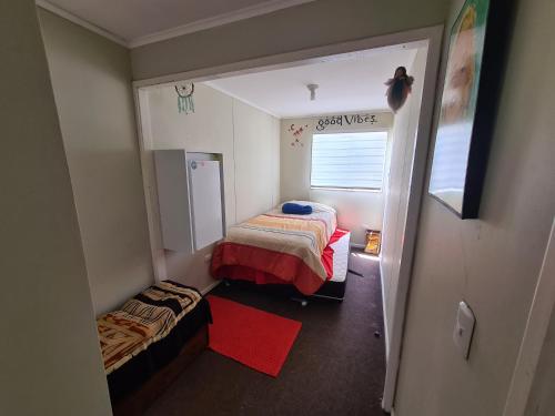 a small room with two beds and a window at Casa Rucapillan Villarrica in Villarrica