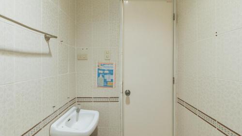 a bathroom with a sink and a toilet and a shower at Casa Demetria Duplex Hot Spring Resort Laguna in Pansol