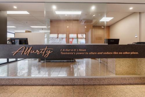 an empty lobby with a sign for an airport at Allurity Hotel in Hobart