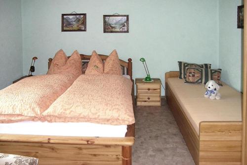 a bedroom with two beds with pillows and a teddy bear at Cottage, Jagdhof in Judenbach