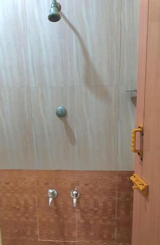 a shower with two water fixtures in a bathroom at Hallima Service Apartments Home Stay purpose Guest House 2 in Pudukkottai