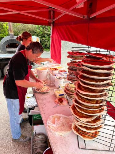 a man standing at a table with a stack of food at BIG4 Apollo Bay Pisces Holiday Park in Apollo Bay