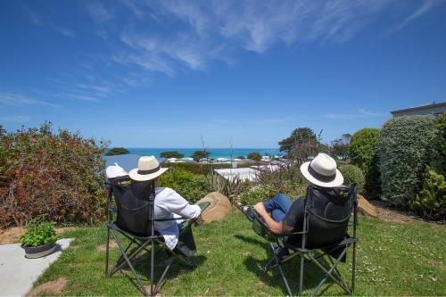 two people sitting in chairs in the grass at BIG4 Apollo Bay Pisces Holiday Park in Apollo Bay
