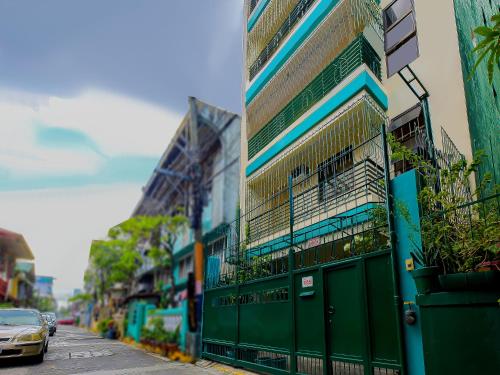 a car parked next to a green building at OYO 840 Orangenest Apartelle in Manila