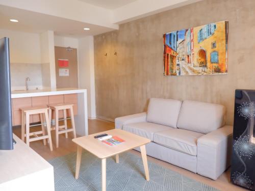 a living room with a couch and a table at Swiss-Belexpress Cilegon in Cilegon