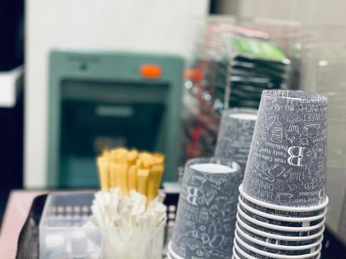a stack of plates and cups on a table at Hotel Halrotto Fukuoka Hakata in Fukuoka