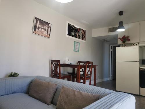 a living room with a couch and a kitchen with a table at Pasadena single house in Pasadena