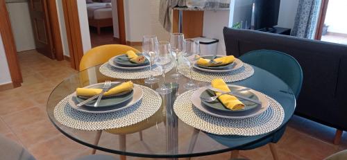 een glazen tafel met borden voedsel erop bij Apartaments By Rentalbir in Albir