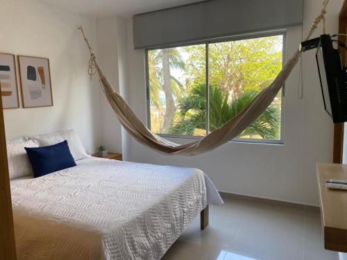a bedroom with a bed and a large window at Magico Apartamento Frente al Mar 2 Habitaciones B11A in Coveñas
