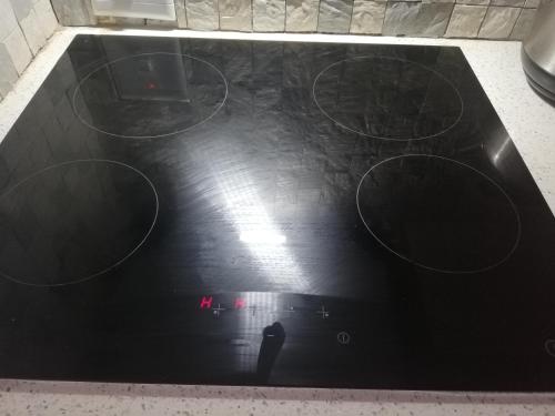 a black counter top with a person standing on it at The Penthouse in Port Edward