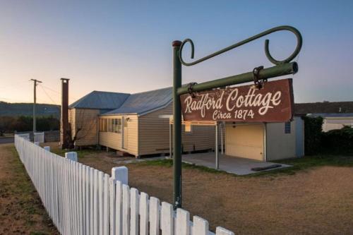 a sign for a restaurant in front of a building at The Radford Couples Cottage Heart of Stanthorpe in Stanthorpe