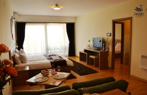 a bedroom with a bed and a living room at Park Lakeside Ohrid in Ohrid