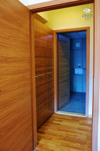 a wooden door in a room with a mirror at Park Lakeside Ohrid in Ohrid