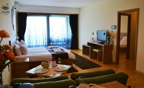 a hotel room with a bed and a television at Park Lakeside Ohrid in Ohrid