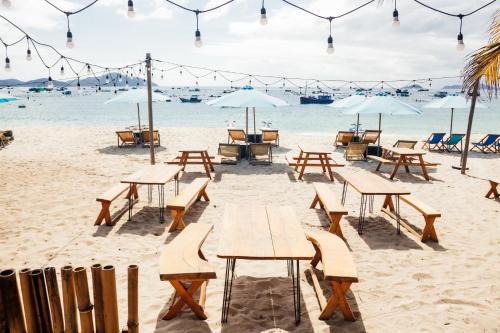 a group of picnic tables on the beach at Villa Đảo Hoa Vàng Cam Ranh - Venuestay in Cam Ranh