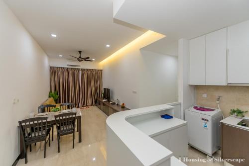 a kitchen and dining room with a table and chairs at Silverscape Deluxe Melaka by I Housing in Melaka