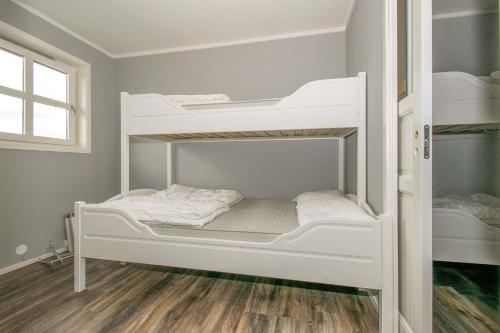 two white bunk beds in a room at Skitorget Apartments in Trysil