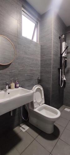 a bathroom with a toilet and a sink and a mirror at Bukit Rimau Instagrammable 2 Bedroom Apartment With Pool View up to 5 PAX in Shah Alam