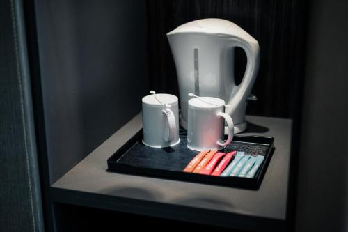 a table with a blender and two mugs on it at Le'venue Hotel in Bangi