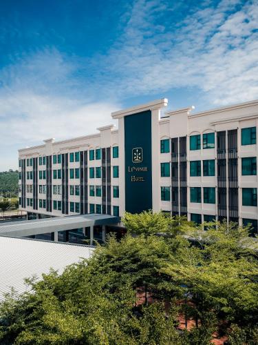 a large white building with a sign on it at Le'venue Hotel in Bangi
