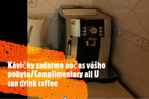 a coffee machine with an orange ribbon next to it at Tatralandia Apartmán 341 in Liptovský Mikuláš