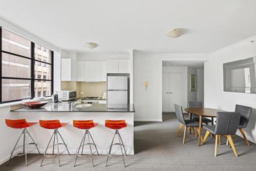 a kitchen and dining room with a table and chairs at NAPI26N - Napier Vistas in Sydney