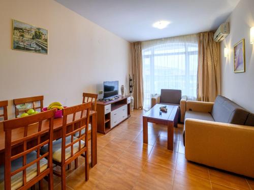 a living room with a couch and a table at Apartcomplex Panorama Dreams in Sveti Vlas