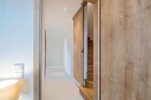a room with a wooden door and a staircase at Ferienwohnung Josef in Gilching
