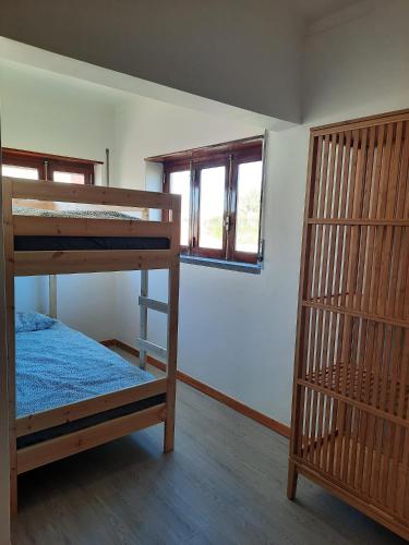 a room with two bunk beds and a window at Casa d'Avo - Cascais-Estoril in São Domingos de Rana