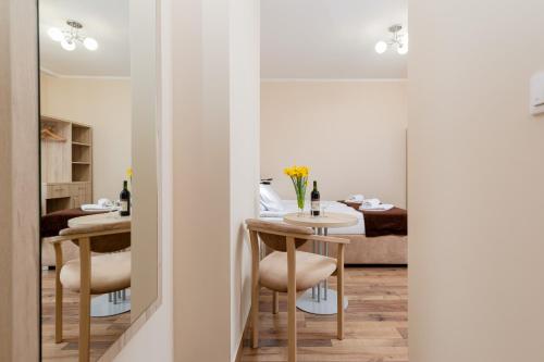 a dining room with a table and chairs and a bedroom at Villa Nadzieja in Międzyzdroje