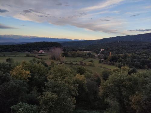an aerial view of a field with trees and mountains at Alojamiento MAS EL CASTELL DEL BRULL in El Brull